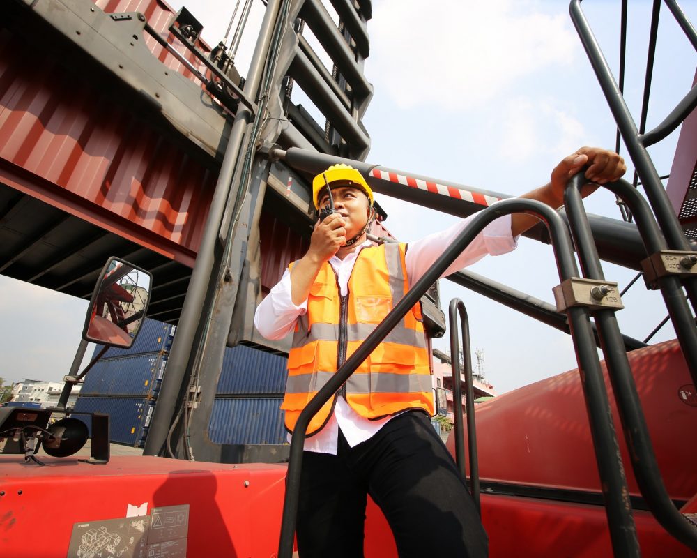 Foreman control Container Cargo freight ship at industry. Transportation and logistic concept.